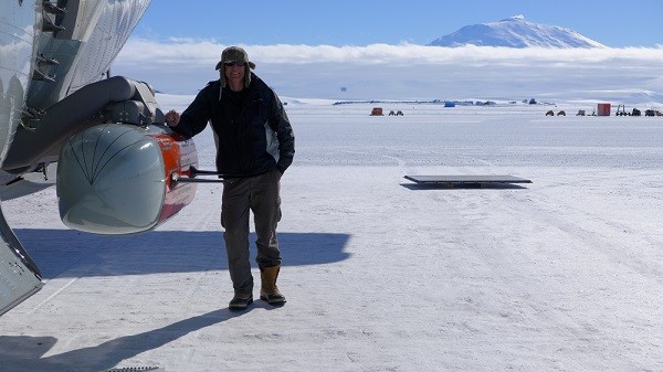 Frearson standing next to the IcePod after installing it onto a military LC-130 Hercules aircraft in Antarctica.