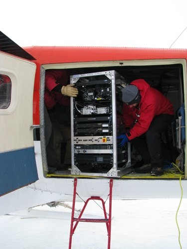 Rack with gravity sensor being installed inside airplane. Photo: Michael Studinger (LDEO)