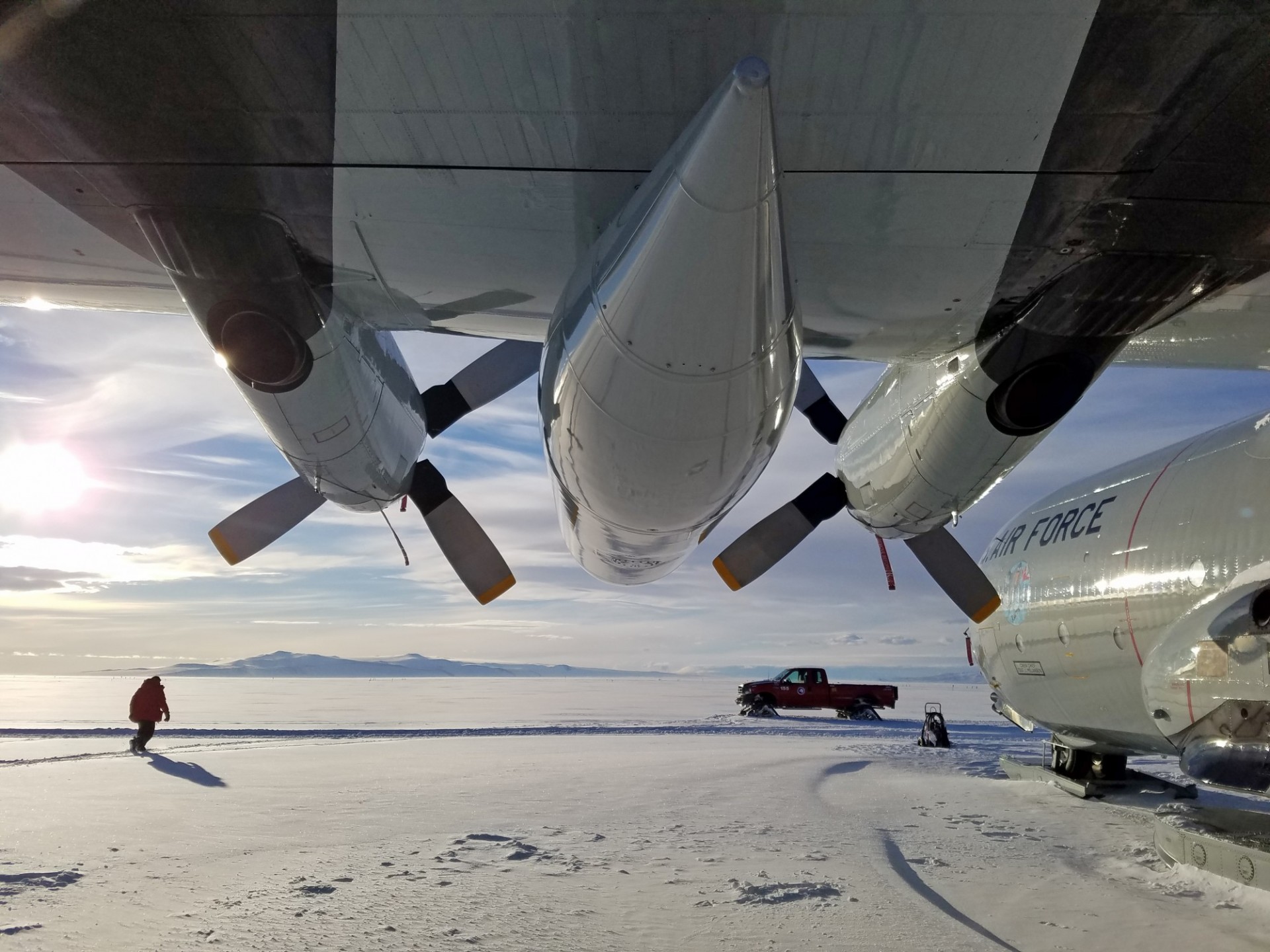 Photo shot from under aircraft wing and propellers, on Ross Ice Shelf at Williams Airfield. Photo: Beth Burton (USGS)