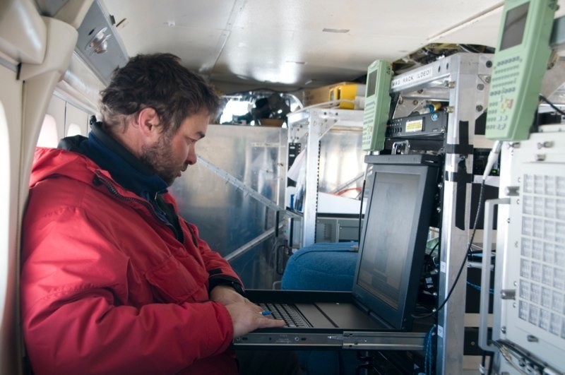 Field scientist monitoring sensors inside Twin Otter during survey flight. Photo: Michael Studinger (LDEO) Field scientist inside Twin Otter monitoring sensors during flight. Photo: Michael Studinger (LDEO)