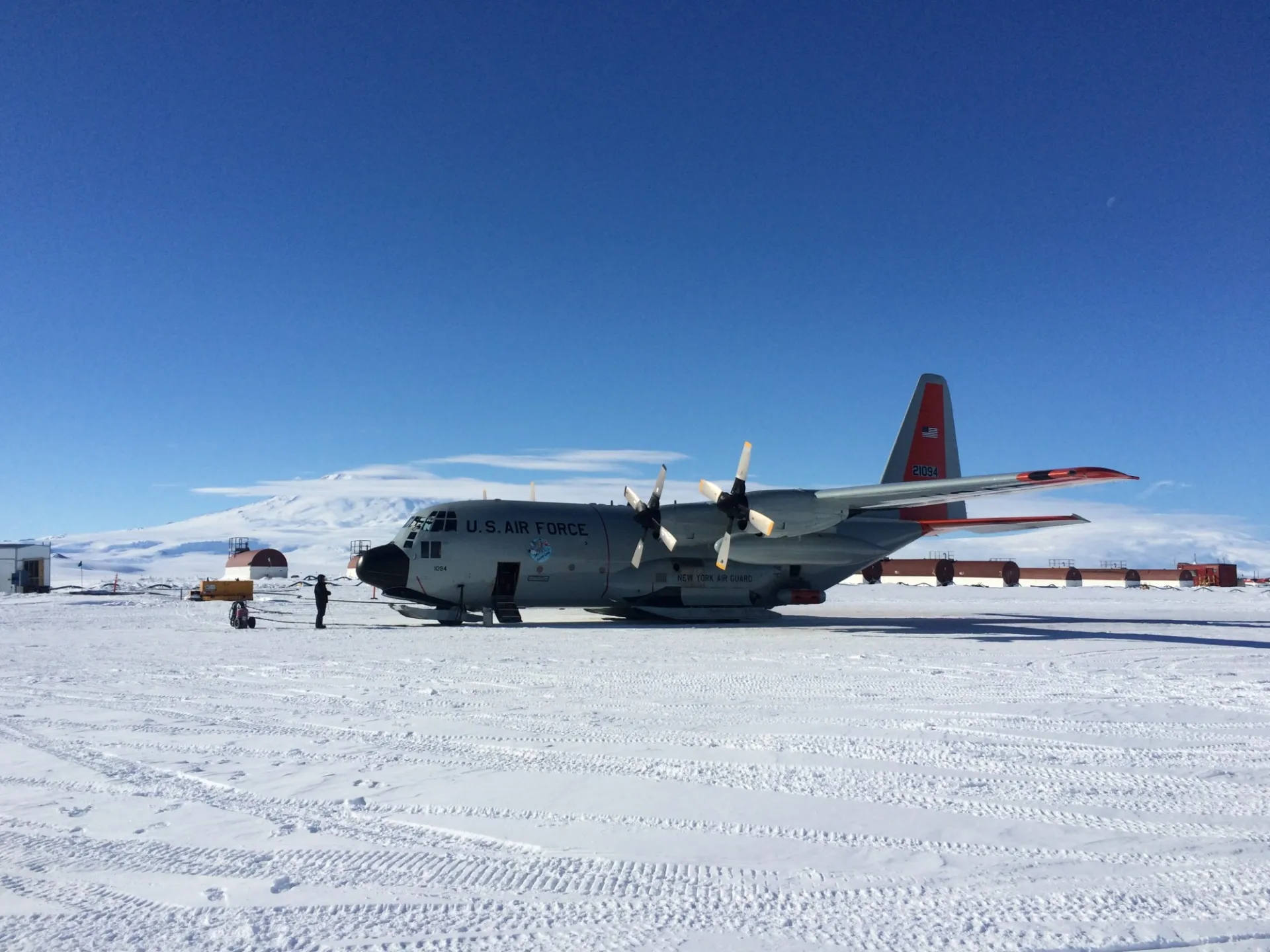 IcePod attached to LC-130 at William's Airfield, Antarctica. Mount Erebus in the background. Photo: Isabel Cordero (LDEO)
